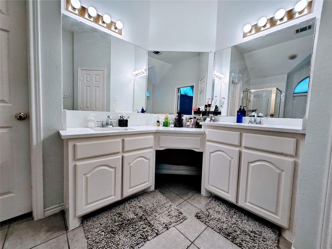 Bathroom with tile patterned flooring, double vanity, and a stall shower | Image 23