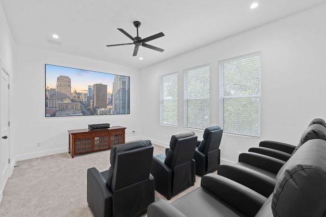Carpeted cinema room featuring recessed lighting, baseboards, ceiling fan and lots of seating | Image 31