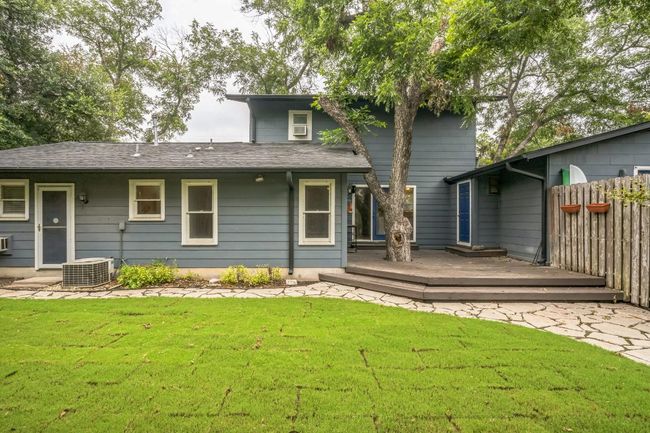 Back of house with a wooden deck and a shingled roof | Image 15