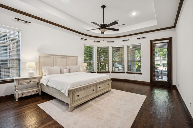 Bedroom with a raised ceiling, hardwood / wood-style floors, recessed lighting, and ceiling fan | Image 7