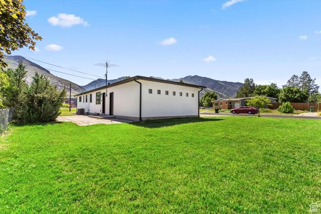 View of front of home with a mountain view and a patio | Image 35