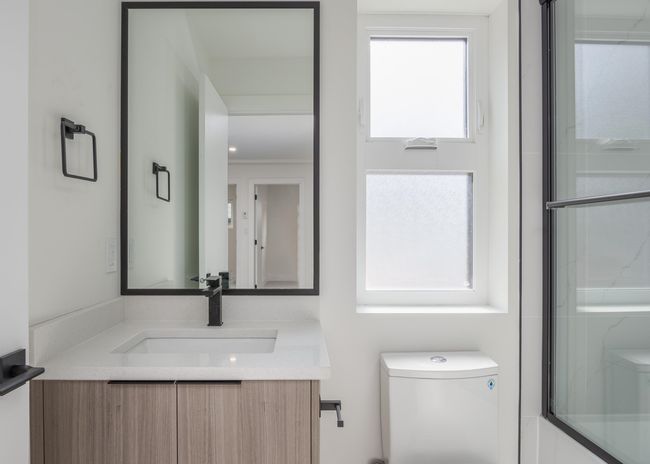 Bathroom featuring toilet and vanity | Image 35