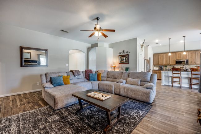 Living room with hardwood / wood-style flooring and ceiling fan | Image 10