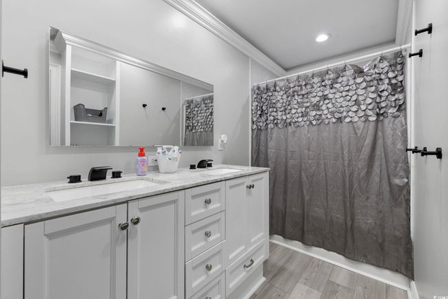 Bathroom with double vanity, wood finished floors, and ornamental molding | Image 19