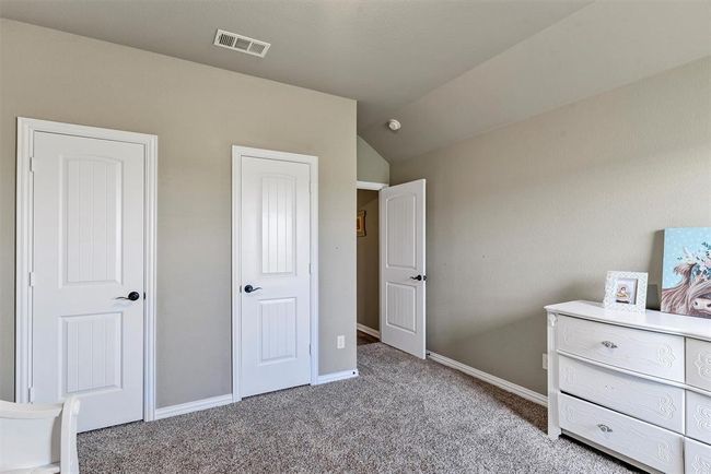 Unfurnished bedroom with carpet floors and lofted ceiling | Image 24