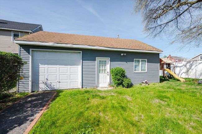 Back of house featuring a yard, aphalt driveway, a playground, and an outbuilding | Image 22