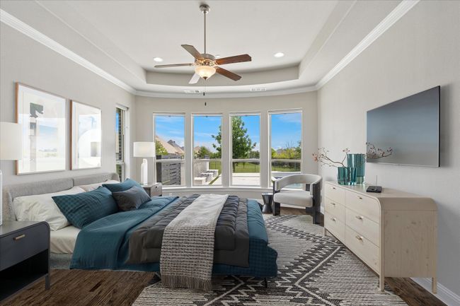 Virtually Staged primary bedroom with a raised ceiling, crown molding, recessed lighting, and ceiling fan | Image 18