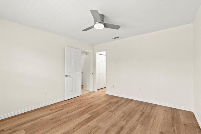 Bedroom features a new light and ceiling fan | Image 22