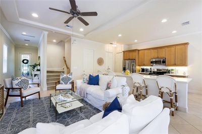 Living room featuring tile patterned floors, crown molding, and ceiling fan | Image 1