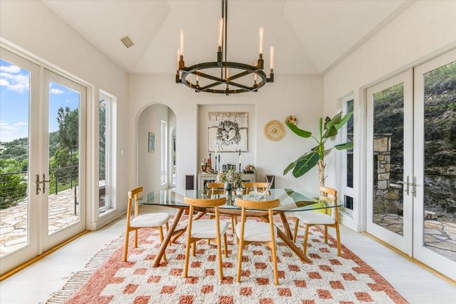 Sunroom / solarium with french doors, arched walkways, a chandelier, and lofted ceiling | Image 13