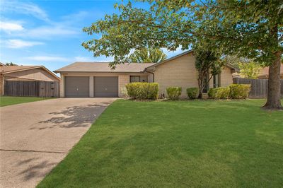 Ranch-style house featuring a front yard and a garage | Image 3