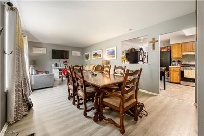 Dining space with light hardwood / wood-style floors and ceiling fan | Image 3