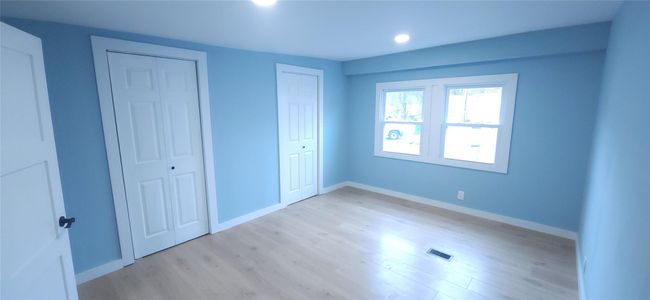 Unfurnished bedroom featuring recessed lighting, visible vents, light wood-type flooring, and baseboards | Image 23