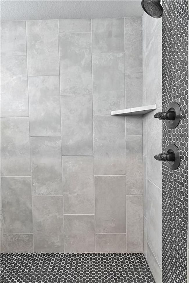 Bathroom featuring tiled shower | Image 28