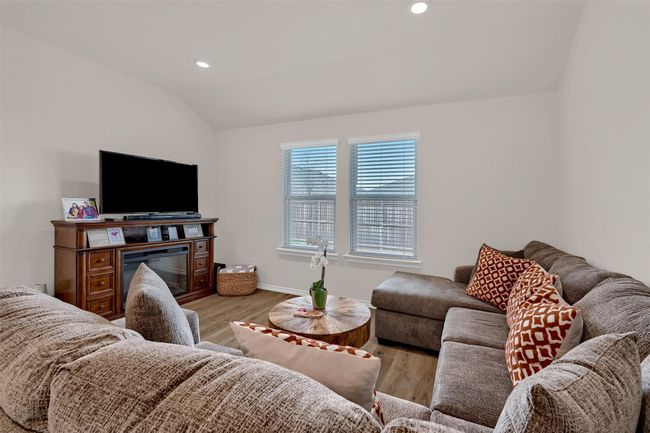 Living area featuring vaulted ceiling, light wood-style floors, and recessed lighting | Image 6
