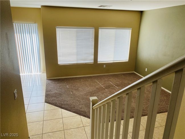 Stairs with visible vents, carpet floors, baseboards, and tile patterned flooring | Image 25