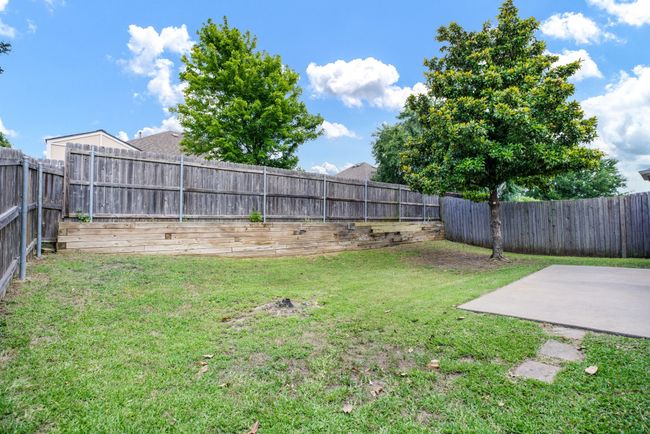 Fenced backyard featuring a patio area | Image 4