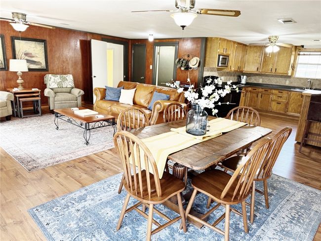 Dining room with visible vents, light wood-type flooring, and a ceiling fan | Image 9