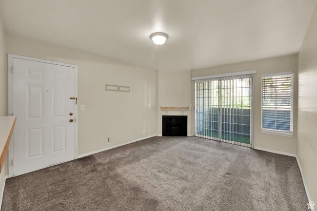 Living room featuring carpet floors and a fireplace | Image 13