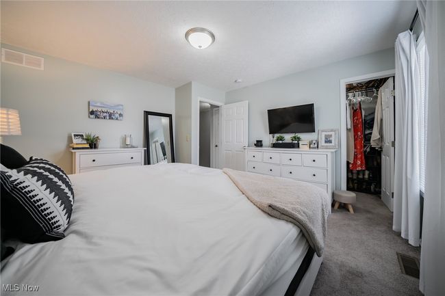 Bedroom with a spacious closet, a closet, and carpet flooring | Image 16