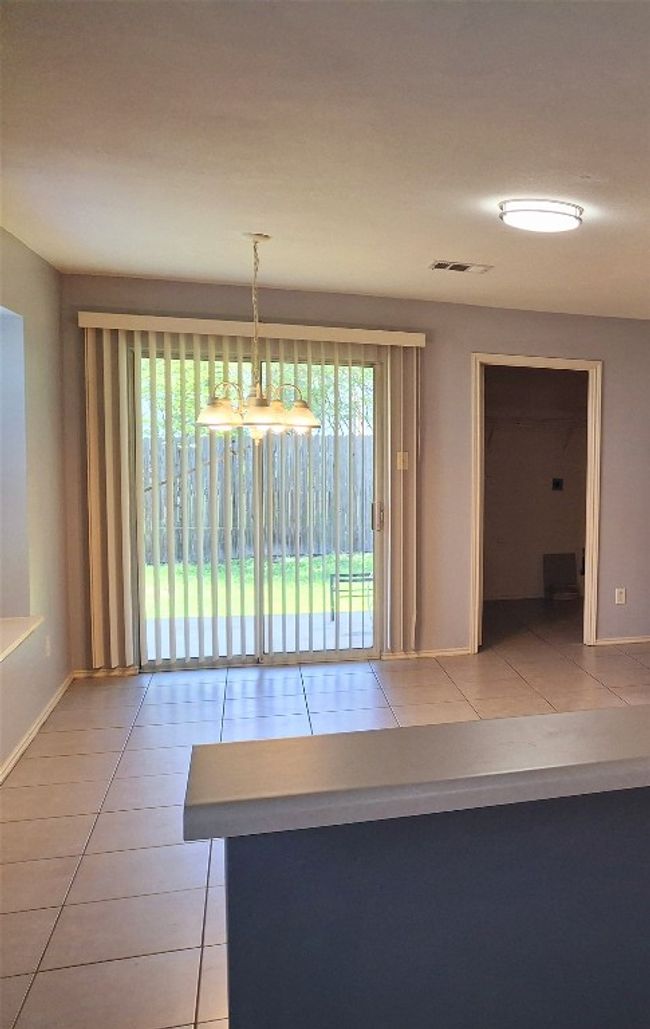 Dining area in front of covered patio | Image 6