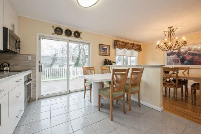 Dining space with baseboards, ornamental molding, and a chandelier | Image 9