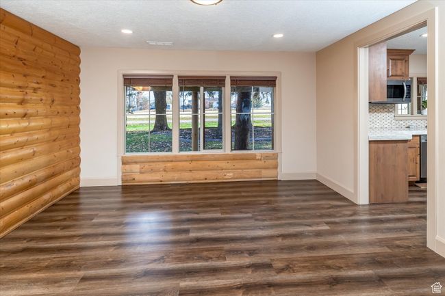Unfurnished room featuring plenty of natural light, dark wood-style flooring, recessed lighting, and a textured ceiling | Image 26