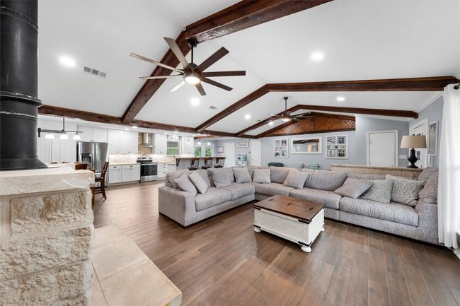 Living area featuring ceiling fan, dark wood-style floors, and recessed lighting | Image 8