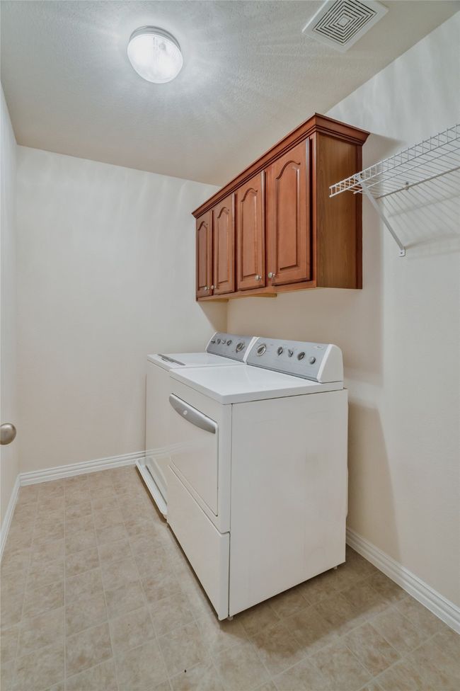 Laundry room separate washer and dryer (and they will convey) cabinet space, and light patterned floors | Image 16