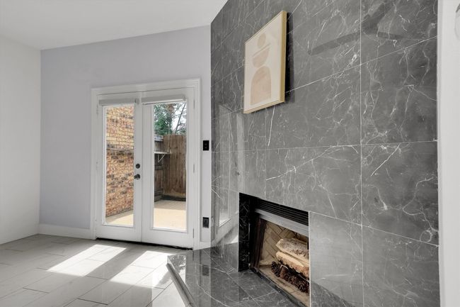Doorway featuring marble finish floors, a fireplace, and french doors | Image 8