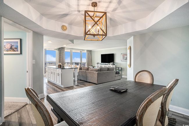 Dining room with a chandelier and wood finished floors | Image 10