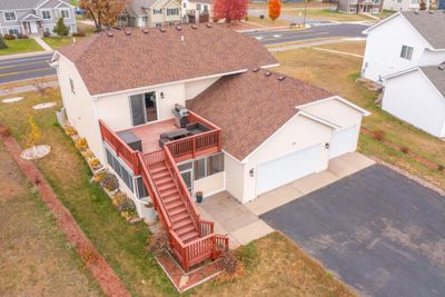 Rear of home with deck, enclosed patio with hot tub and oversized 3 car garage. | Image 2