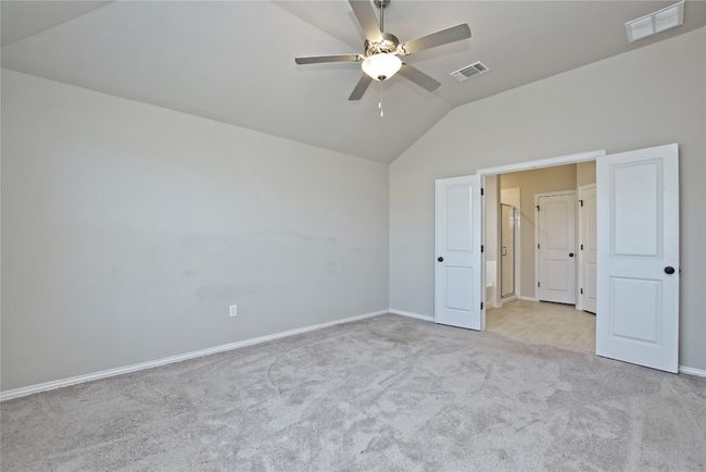 Unfurnished bedroom featuring visible vents, carpet flooring, baseboards, and lofted ceiling | Image 15