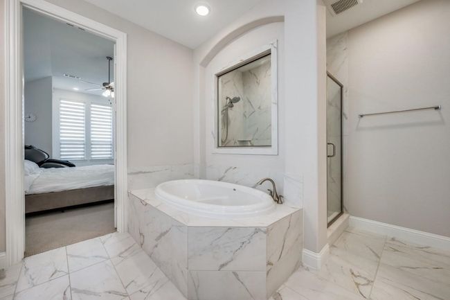 Full bathroom with marble finish flooring, a marble finish shower, a bath, connected bathroom, and a ceiling fan | Image 31