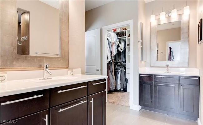 Bathroom with a spacious closet, two vanities, a sink, and tile patterned flooring | Image 11