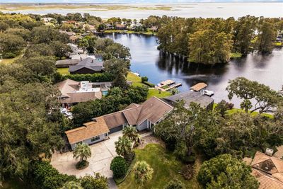 Aerial view of the property showing the lake and circular driveway. | Image 1