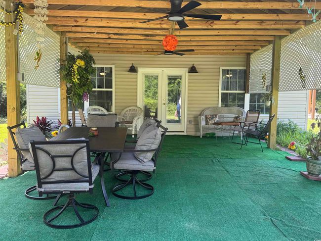 View of patio featuring ceiling fan and outdoor dining space | Image 21