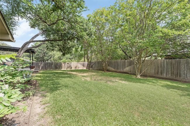 The large almost quarter acre lot provides for a sizable fenced-on backyard complete with updated landscaping borders and a gorgeous, covered patio add on with a gas fire-pit. | Image 33