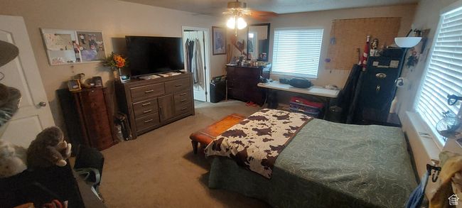 Bedroom with light carpet and a ceiling fan | Image 6