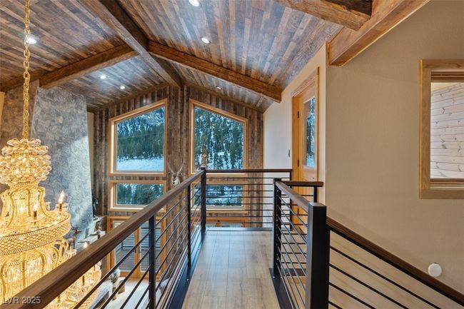 Hall featuring vaulted ceiling with beams, wooden ceiling, wood finished floors, and an upstairs landing | Image 18