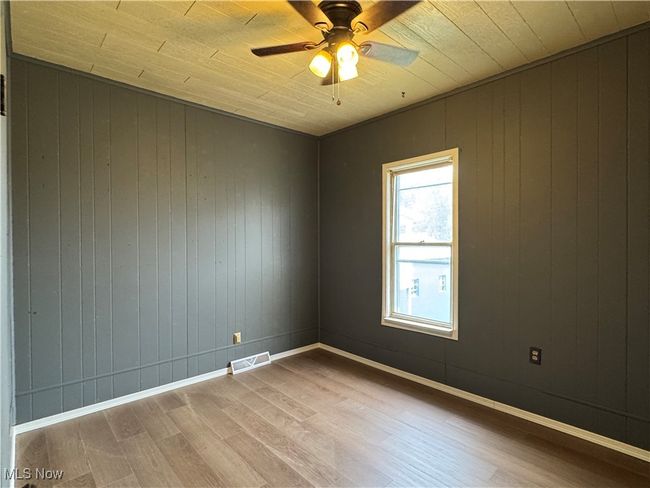 Spare room featuring hardwood / wood-style flooring and ceiling fan | Image 10