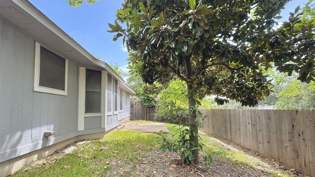 Fenced backyard with a patio area | Image 16