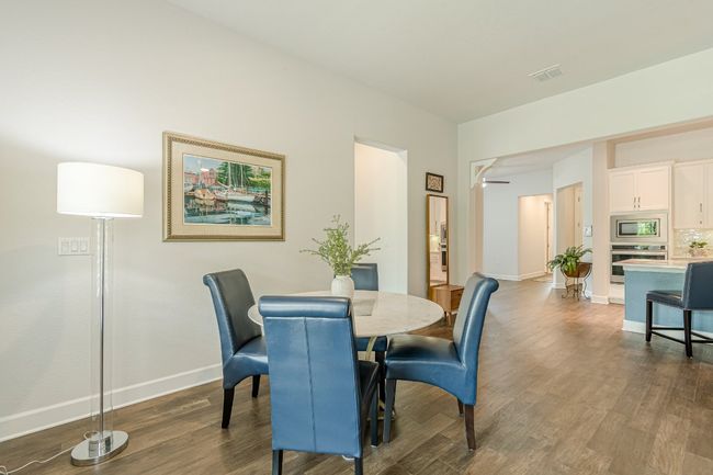 Dining area with baseboards and dark wood-style floors | Image 24