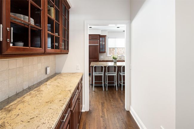 Butlers pantry between formal dining room and kitchen with storage. | Image 9