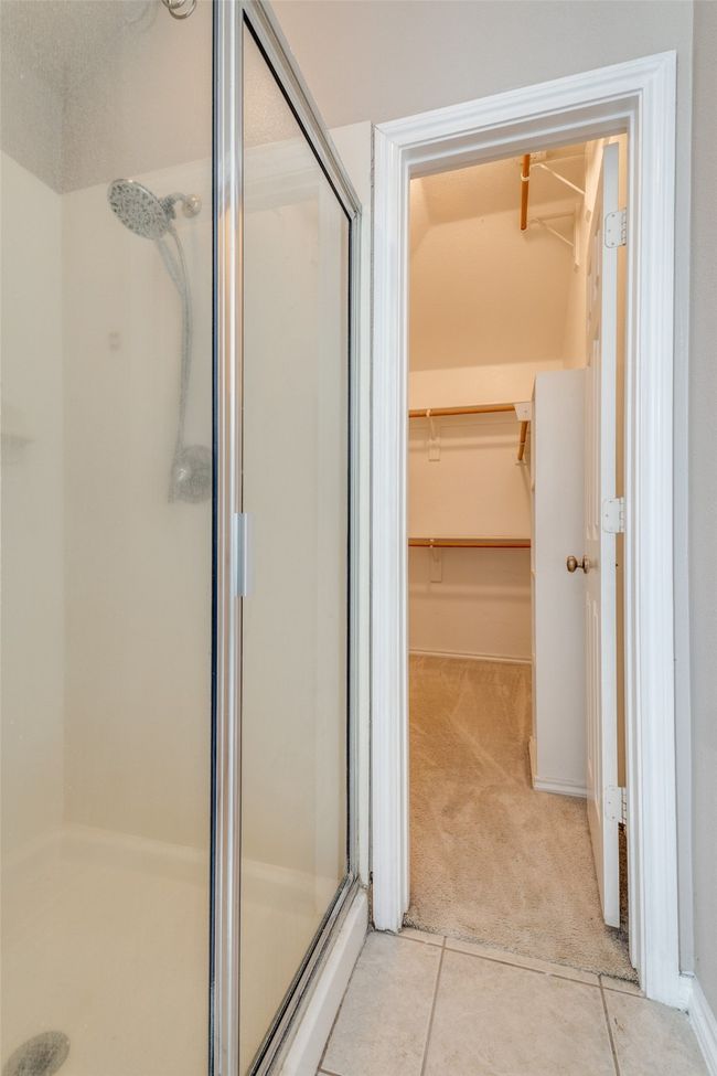 Bathroom with a stall shower, a spacious closet, and tile patterned floors | Image 23