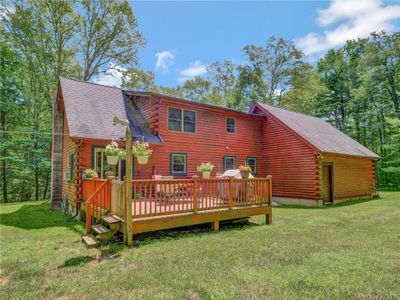 Back of house with a deck and a lawn | Image 3