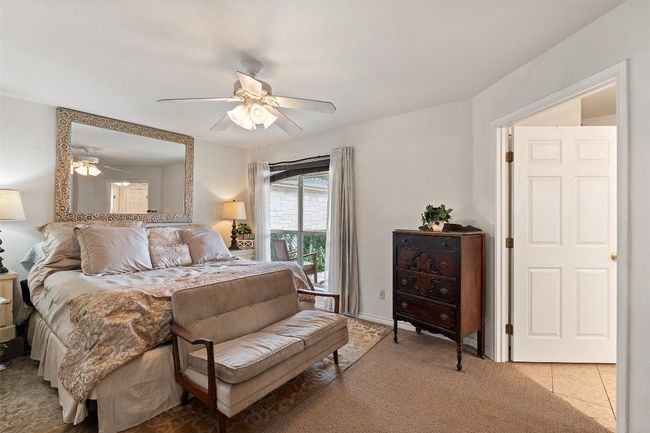 Bedroom with a ceiling fan and light carpet | Image 23