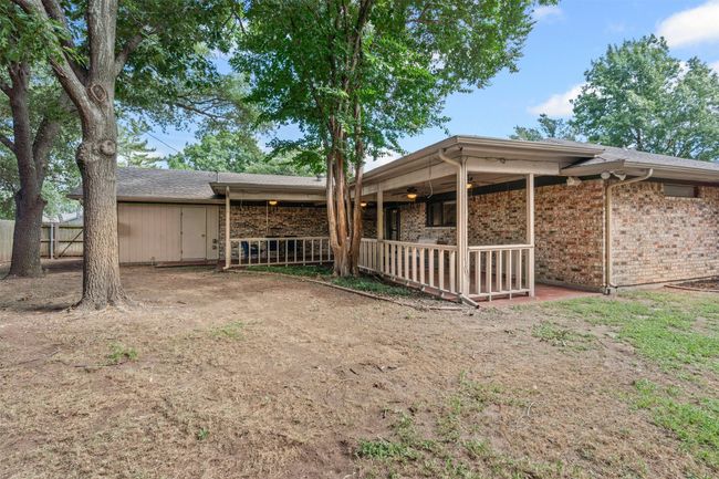 Rear view of house with ceiling fan and brick siding | Image 29