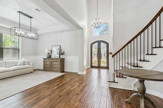 Your view from the family room extends to the front door, passing a beautifully curved staircase that winds its way to the second floor | Image 7