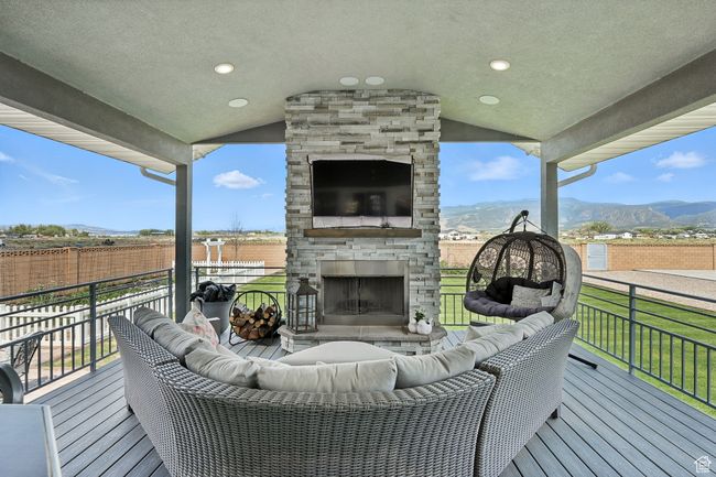Deck featuring an outdoor living space with a fireplace | Image 15